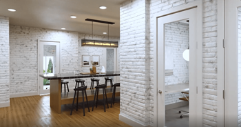 a kitchen with a white brick wall and a bar with chairs